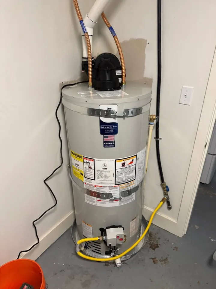 Power-vent gas tank water heater with seismic straps and a yellow flexible gas line