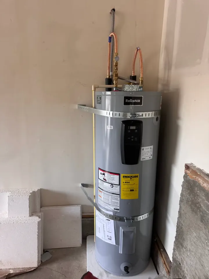 Newly installed electric tank water heater secured with seismic straps